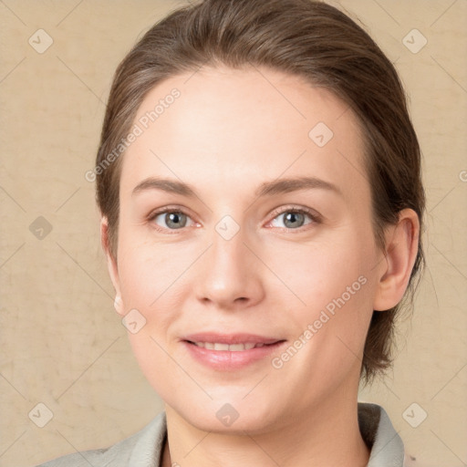 Joyful white young-adult female with medium  brown hair and blue eyes