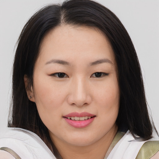 Joyful asian young-adult female with medium  brown hair and brown eyes
