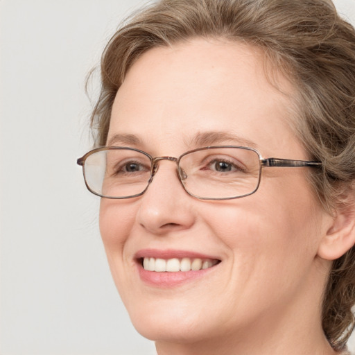 Joyful white adult female with medium  brown hair and blue eyes