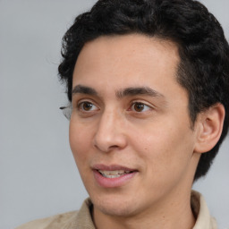 Joyful white adult male with short  black hair and brown eyes