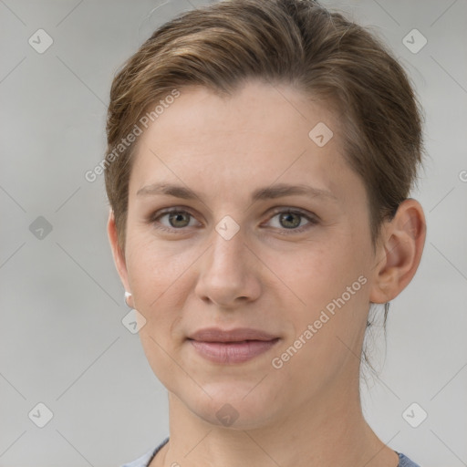 Joyful white young-adult female with short  brown hair and grey eyes