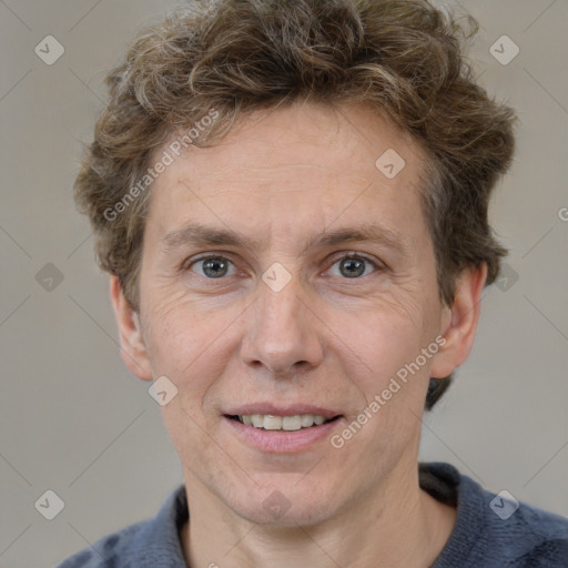 Joyful white adult male with short  brown hair and grey eyes