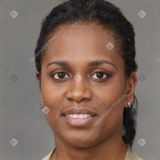 Joyful black young-adult female with short  brown hair and brown eyes