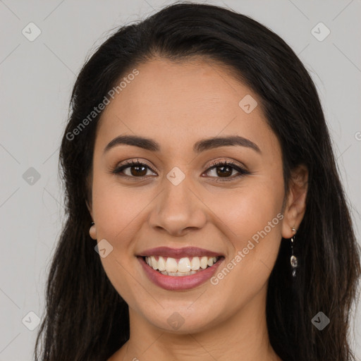 Joyful latino young-adult female with long  brown hair and brown eyes