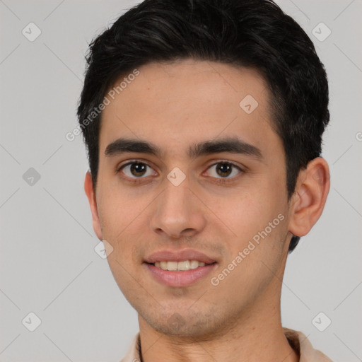 Joyful latino young-adult male with short  black hair and brown eyes