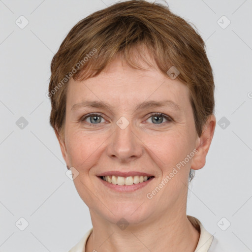 Joyful white young-adult female with short  brown hair and grey eyes