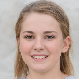 Joyful white young-adult female with medium  brown hair and blue eyes