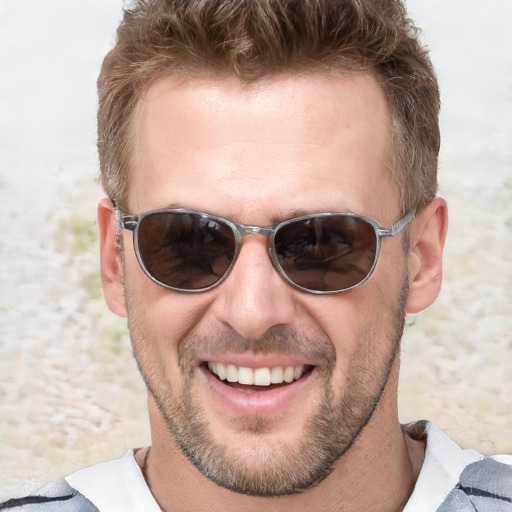 Joyful white adult male with short  brown hair and blue eyes