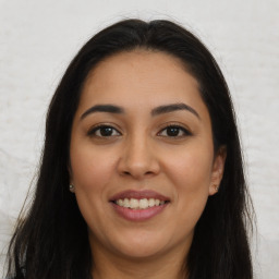 Joyful latino young-adult female with long  brown hair and brown eyes