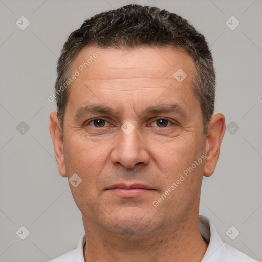 Joyful white adult male with short  brown hair and brown eyes