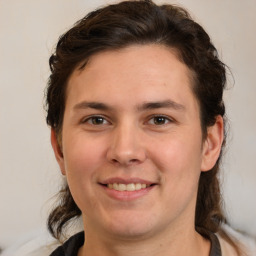 Joyful white young-adult male with medium  brown hair and brown eyes