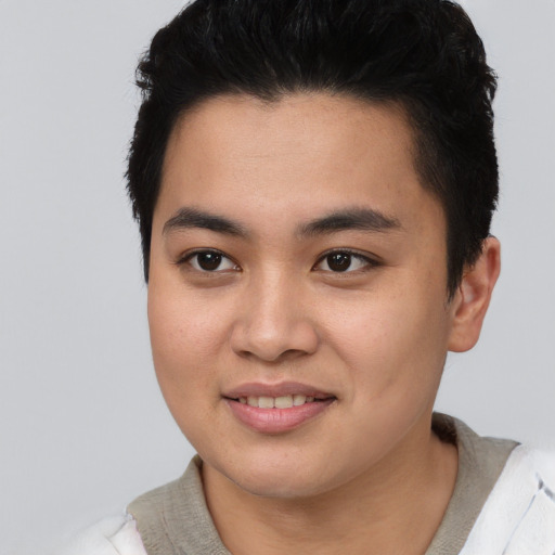 Joyful asian young-adult male with short  black hair and brown eyes
