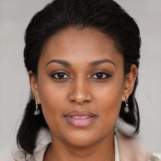 Joyful black young-adult female with medium  brown hair and brown eyes