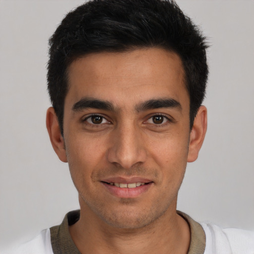 Joyful white young-adult male with short  black hair and brown eyes