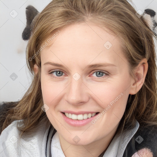 Joyful white young-adult female with medium  brown hair and blue eyes