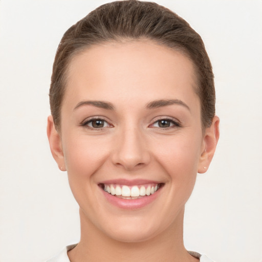 Joyful white young-adult female with short  brown hair and brown eyes