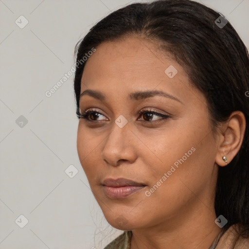 Joyful latino young-adult female with long  brown hair and brown eyes