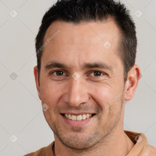 Joyful white adult male with short  brown hair and brown eyes