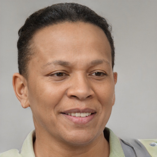 Joyful latino adult female with short  brown hair and brown eyes