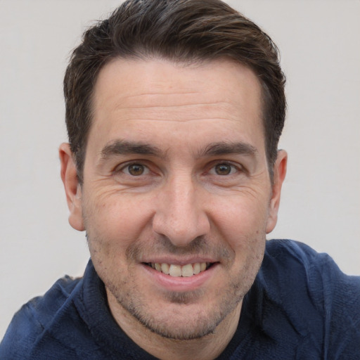 Joyful white adult male with short  brown hair and brown eyes