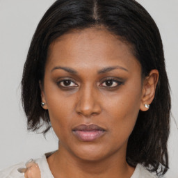 Neutral black young-adult female with medium  brown hair and brown eyes
