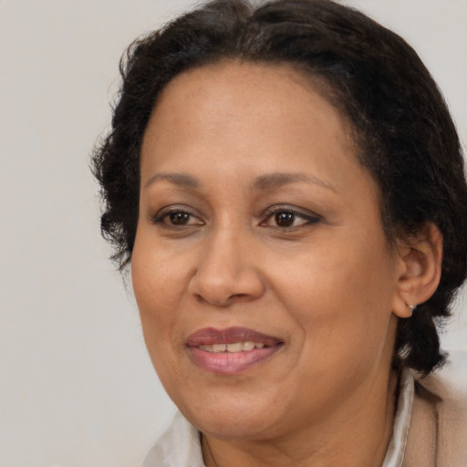 Joyful latino adult female with medium  brown hair and brown eyes