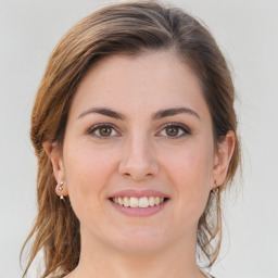 Joyful white young-adult female with medium  brown hair and grey eyes