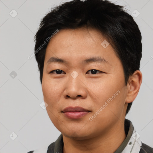 Joyful asian young-adult male with short  brown hair and brown eyes