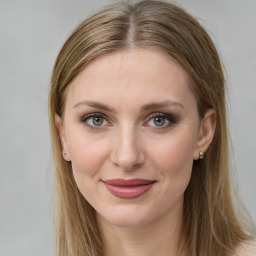 Joyful white young-adult female with long  brown hair and green eyes