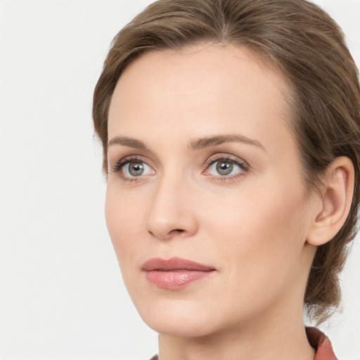 Joyful white young-adult female with medium  brown hair and blue eyes