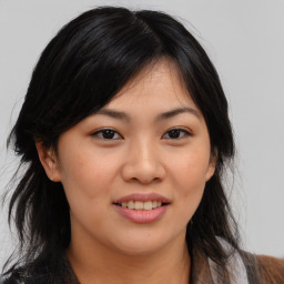 Joyful asian young-adult female with long  brown hair and brown eyes