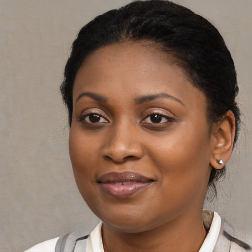 Joyful black young-adult female with medium  black hair and brown eyes