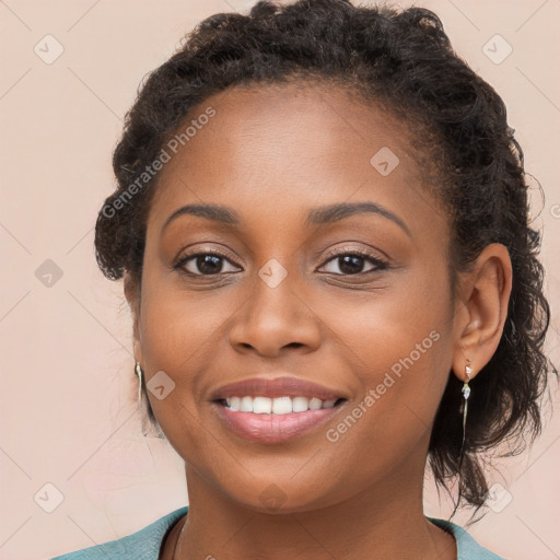 Joyful black young-adult female with long  brown hair and brown eyes