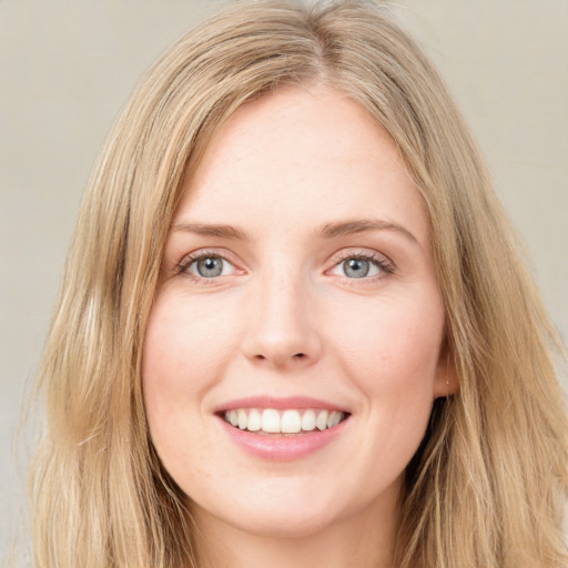 Joyful white young-adult female with long  brown hair and blue eyes