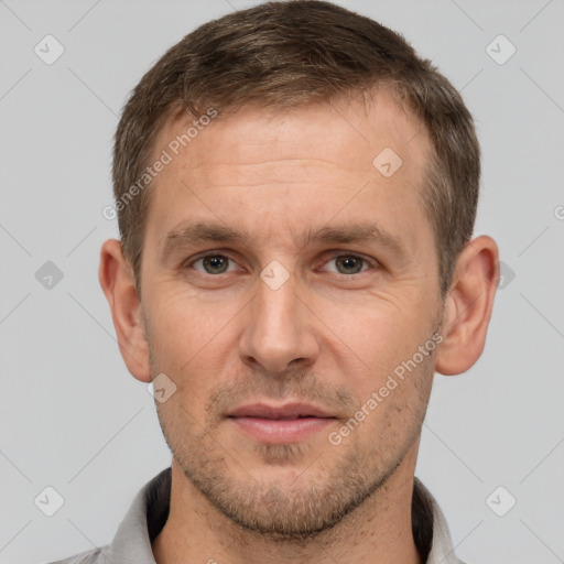 Joyful white adult male with short  brown hair and brown eyes