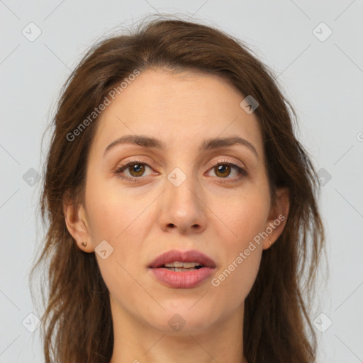 Joyful white adult female with long  brown hair and brown eyes