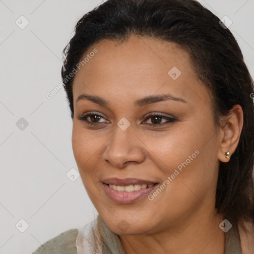 Joyful black young-adult female with long  brown hair and brown eyes