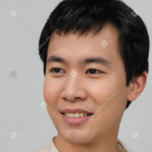 Joyful asian young-adult male with short  black hair and brown eyes