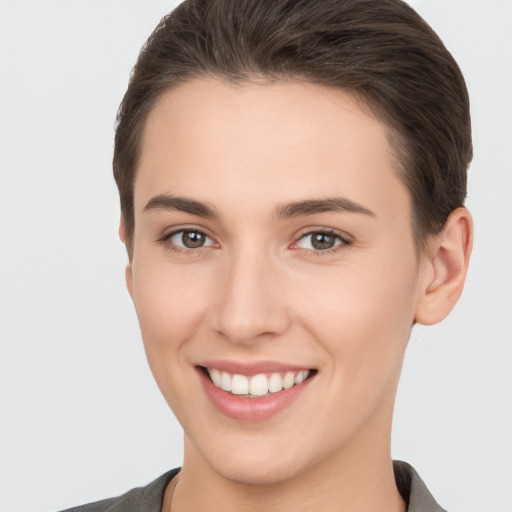 Joyful white young-adult female with short  brown hair and brown eyes