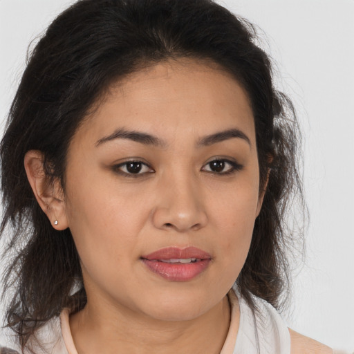Joyful latino young-adult female with medium  brown hair and brown eyes