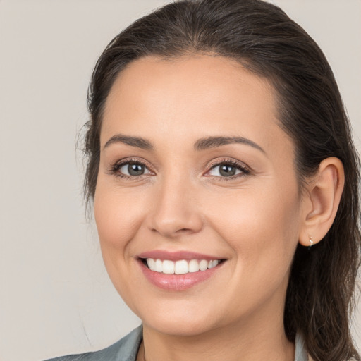 Joyful white young-adult female with medium  brown hair and brown eyes