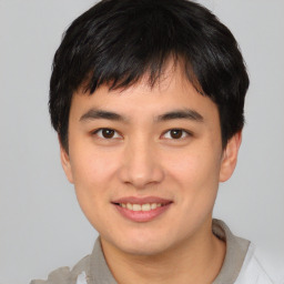 Joyful asian young-adult male with short  brown hair and brown eyes