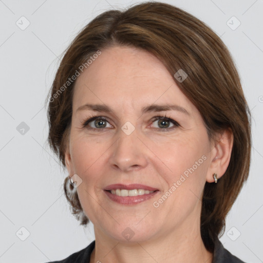 Joyful white adult female with medium  brown hair and grey eyes