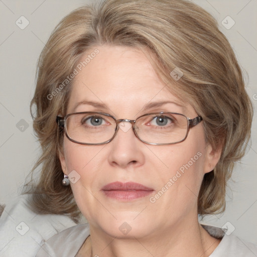 Joyful white adult female with medium  brown hair and blue eyes