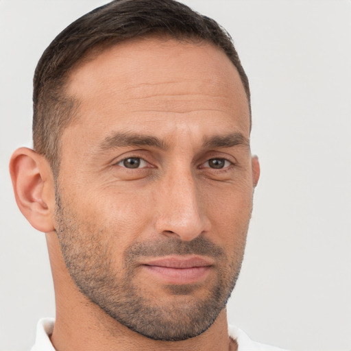 Joyful white adult male with short  brown hair and brown eyes