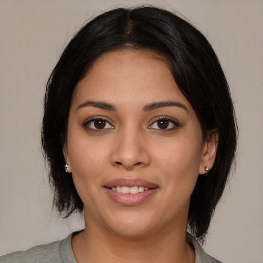 Joyful latino young-adult female with medium  black hair and brown eyes