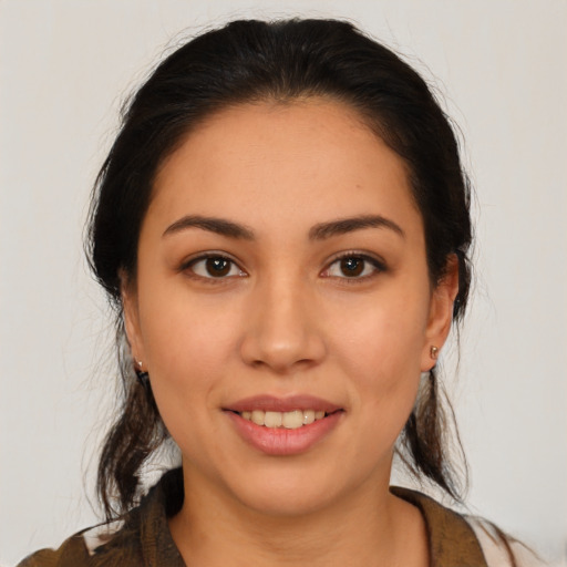 Joyful latino young-adult female with medium  brown hair and brown eyes