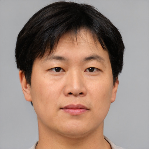 Neutral asian adult male with short  brown hair and brown eyes