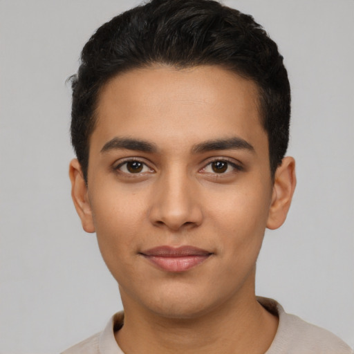 Joyful latino young-adult male with short  black hair and brown eyes