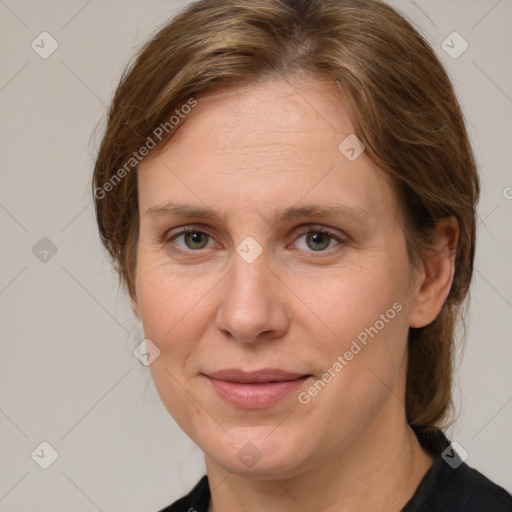 Joyful white adult female with medium  brown hair and grey eyes